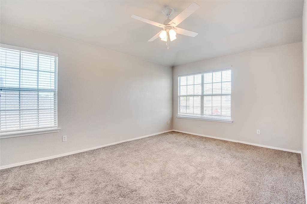 5329 Raven Row, Dallas, TX 75236 Carpeted spare room featuring ceiling fan and a wealth of natural light
