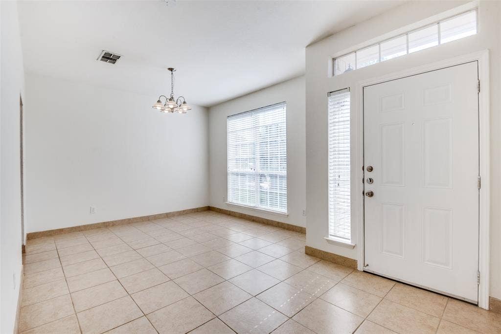 5329 Raven Row, Dallas, TX 75236 Tiled entryway with a notable chandelier