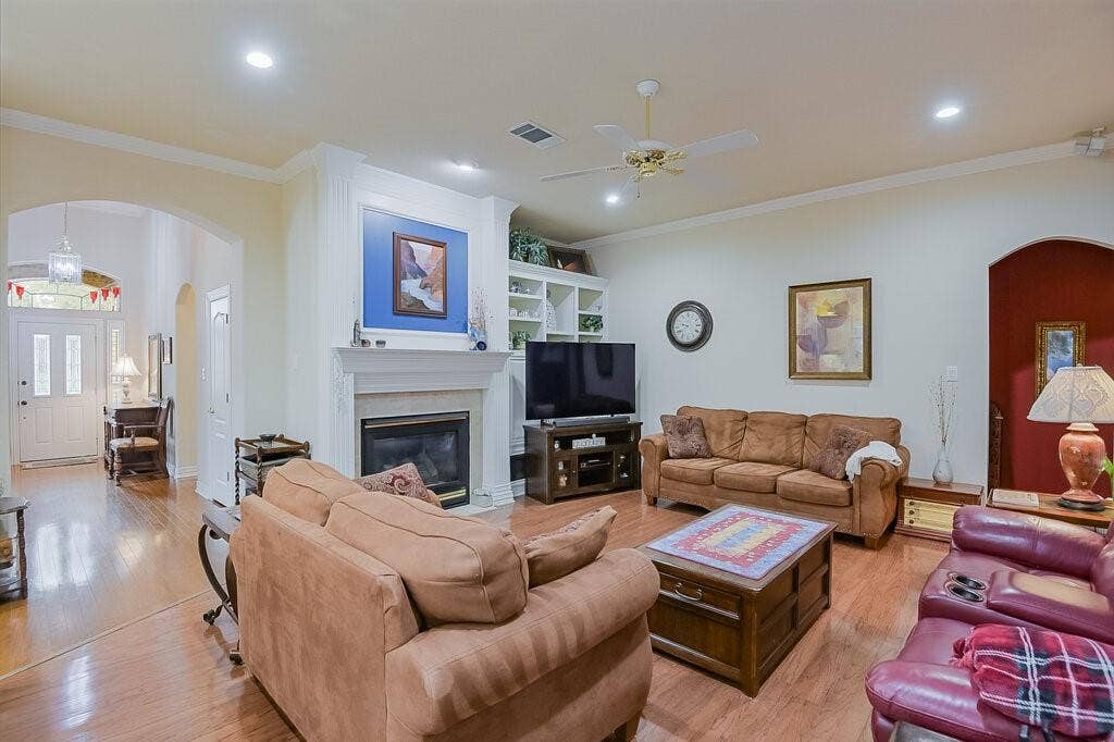 Beautiful wood floors, fireplace and bookshelves.