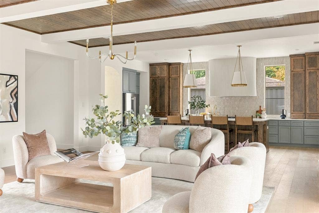 4953 Forest Bend Road, Dallas, TX 75244 Coffered ceiling with wood-finish inlay, white structural beams, custom cabinetry, large kitchen island, and gold-tone pendant lighting