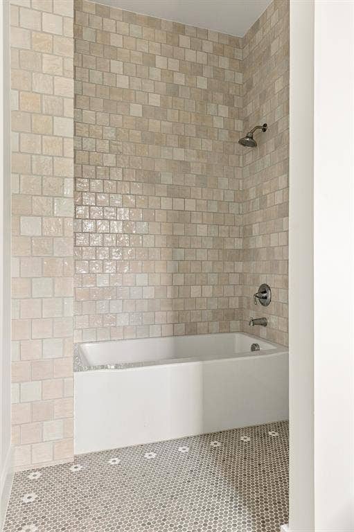 4953 Forest Bend Road, Dallas, TX 75244 Bathtub with a shower head, finished with floor-to-ceiling square tile surround and decorative mosaic tile flooring