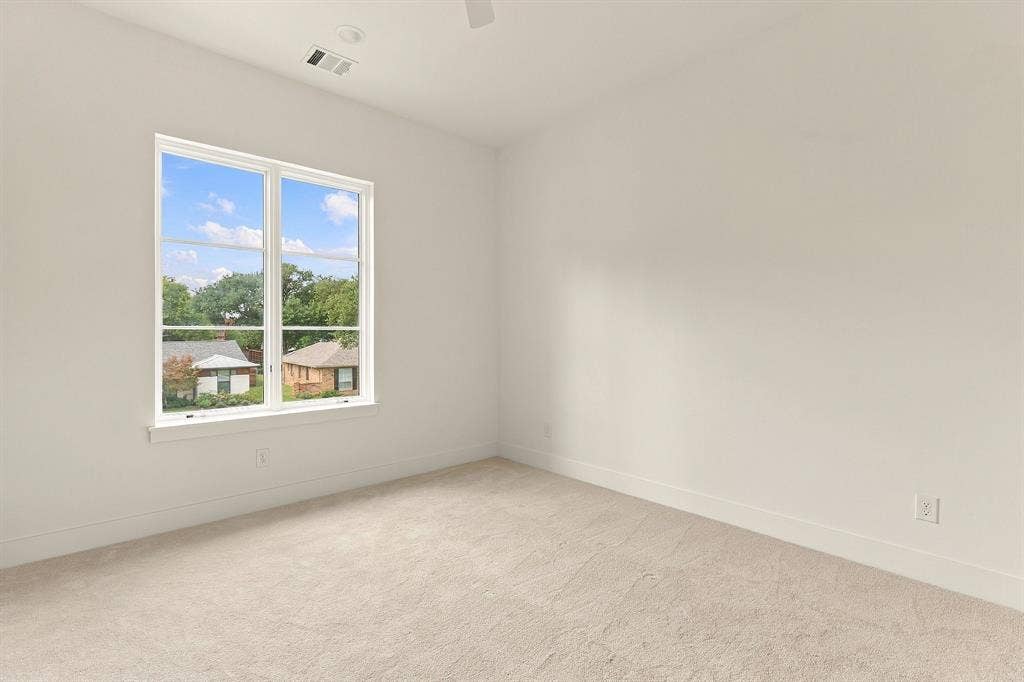 4953 Forest Bend Road, Dallas, TX 75244 Neutral-toned wall finish, wall-to-wall carpeting, large window with multi-pane configuration, and recessed ceiling lighting