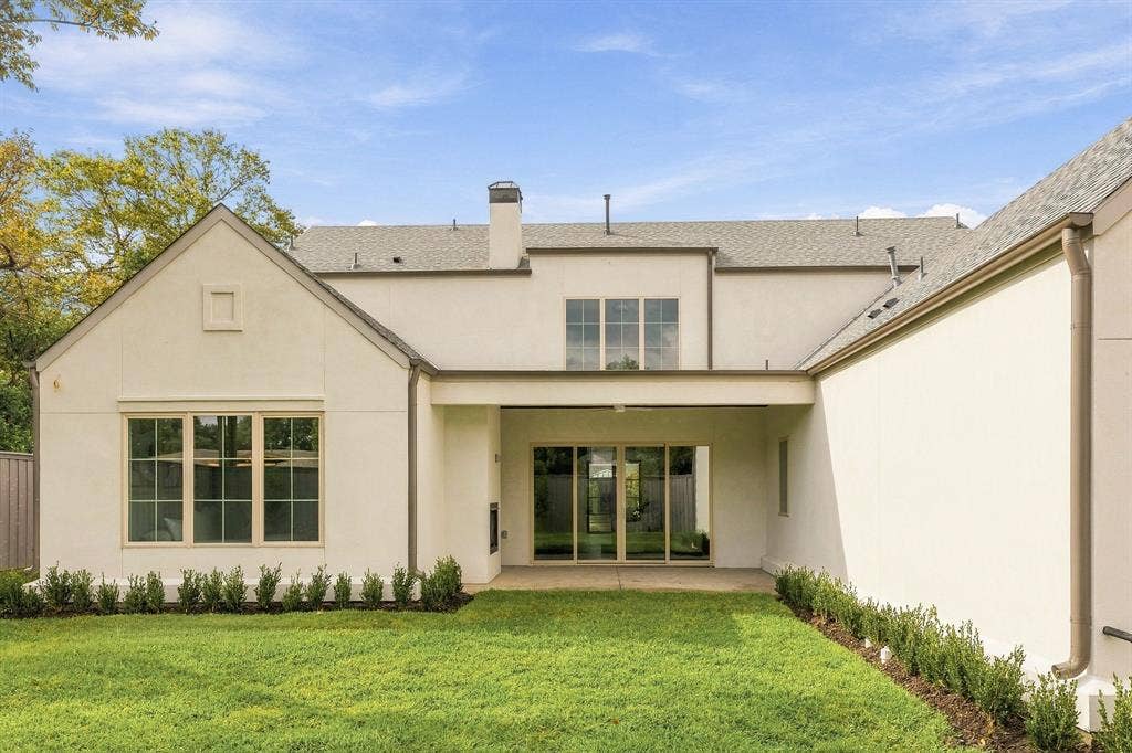 4953 Forest Bend Road, Dallas, TX 75244 Stucco exterior featuring a covered patio, grid-pattern windows, a composition shingle roof, and manicured landscaping