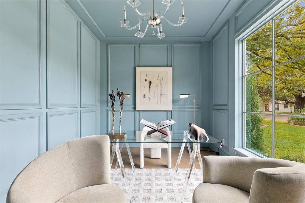 4953 Forest Bend Road, Dallas, TX 75244 Full-height wall paneling, large-format multi-pane window, and an intricate tiered chandelier