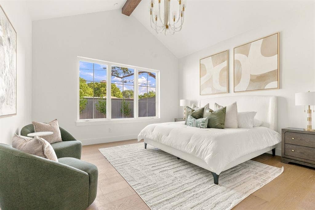 4953 Forest Bend Road, Dallas, TX 75244 Vaulted ceilings featuring an exposed wood beam, large multi-pane windows, and light-toned wood-finish flooring