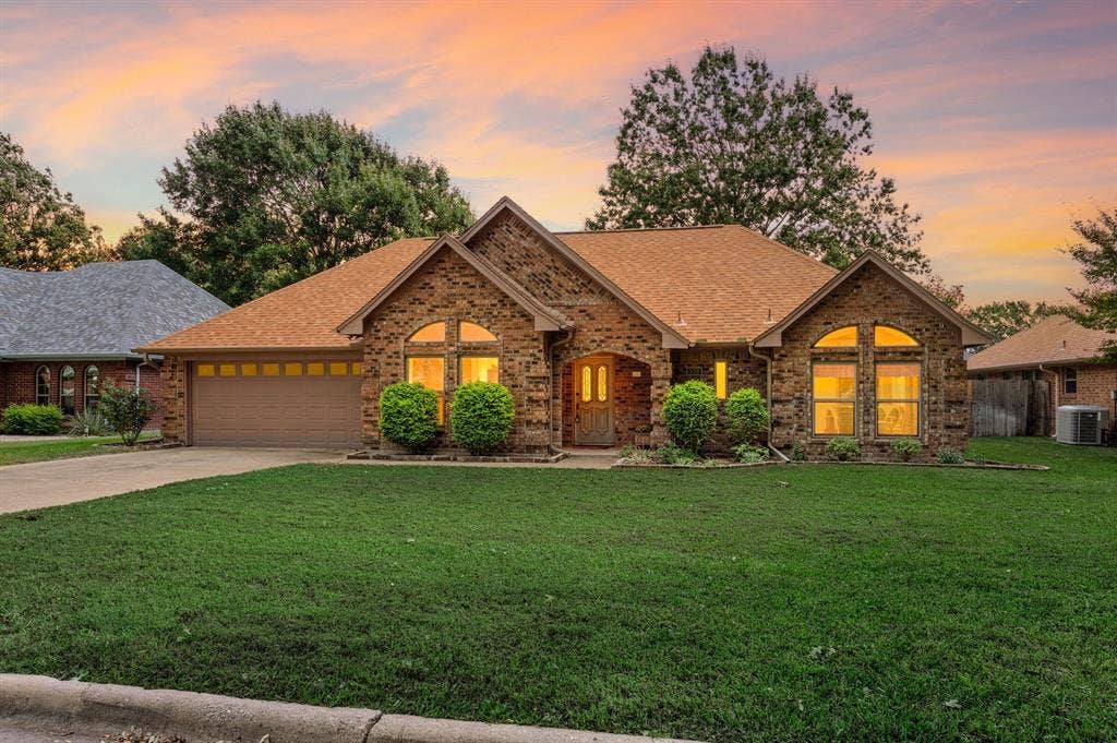 339 Park North Lane, Keller, TX 76248 Brick exterior featuring a multi-gabled roofline, arched windows, covered entryway, and attached multi-car garage