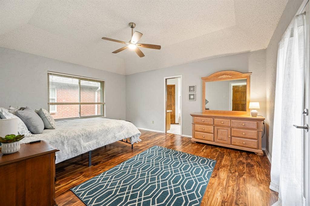 339 Park North Lane, Keller, TX 76248 Tray ceiling, wood-finish flooring, sliding glass door, and ceiling fan