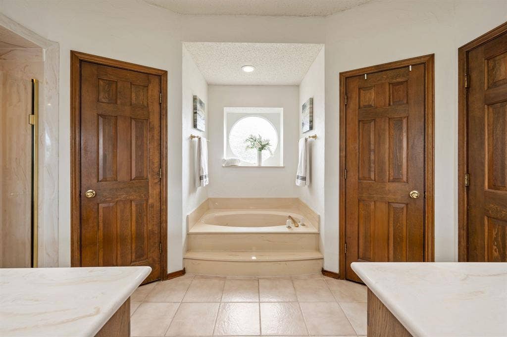 339 Park North Lane, Keller, TX 76248 Primary Spa-Style Master Bath featuring dual vanities with marble-finish countertops, wood-finish flooring, and recessed ceiling lighting