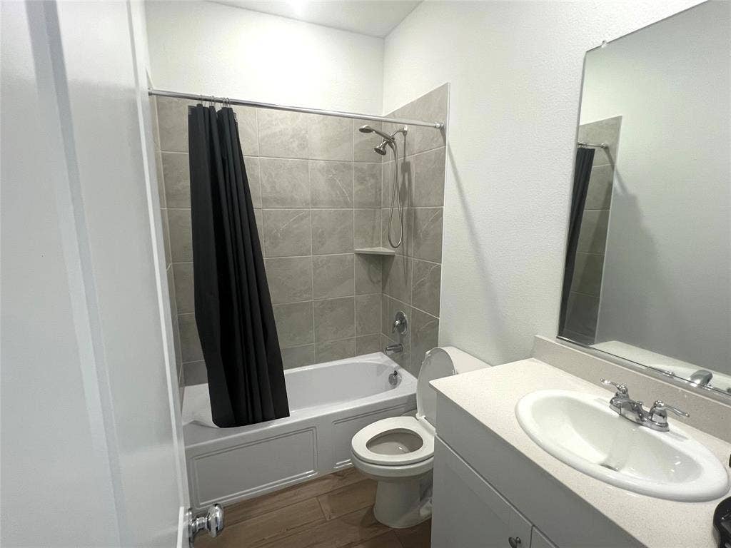 412 Ardsley Lane, Princeton, TX 75407 Full bathroom with large vanity, toilet, and shower / bath combo with shower curtain