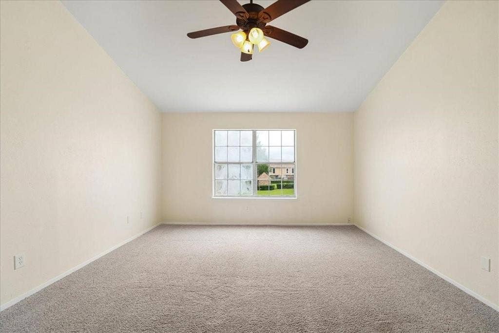 703 Lee Street, #6, Mesquite, TX 75149 Interior space featuring high vaulted ceilings, wall-to-wall carpeting, a large grid-pattern window, and a ceiling fan with integrated multi-bulb lighting
