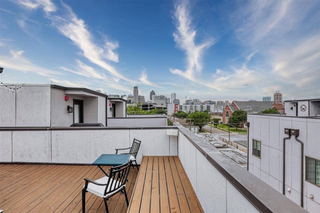 Rooftop terrace with wood-finish decking and perimeter walls