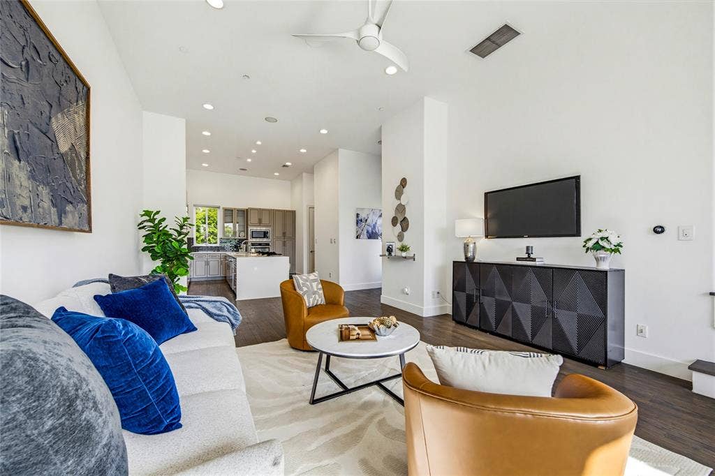 Open-concept space featuring high ceilings, recessed lighting, a modern ceiling fan, and dark wood-finish flooring