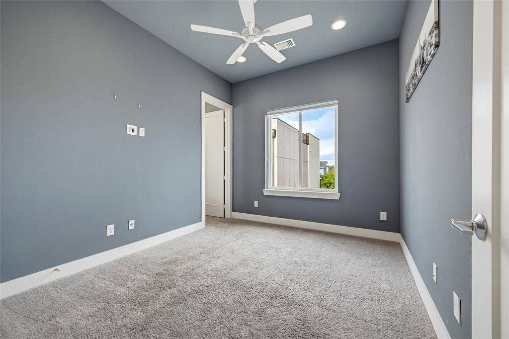 Room featuring high ceilings, neutral carpeting, recessed lighting, and a white ceiling fan with integrated lighting