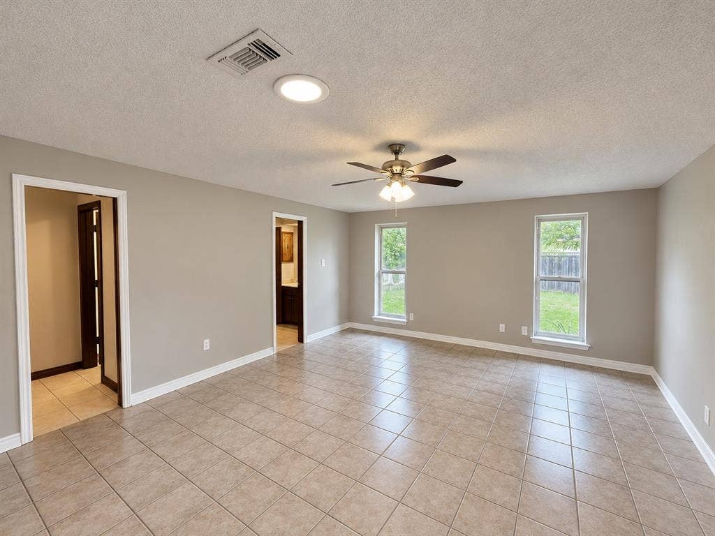 3408 Bellah Court, Irving, TX 75062 Neutral interior featuring tile flooring, dual double-hung windows, and a ceiling fan with integrated lighting