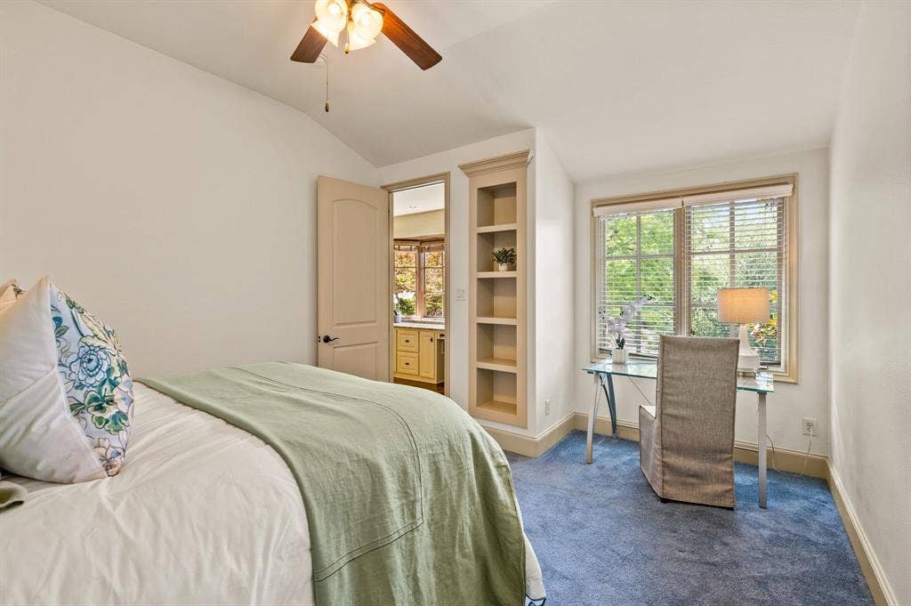 One of three spacious upstairs bedrooms, featuring an expansive window that fills the room with natural light, a private ensuite bath, and a generous walk-in closet.