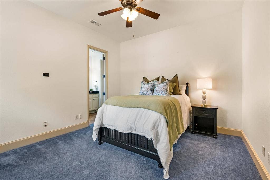 One of three spacious upstairs bedrooms, featuring an expansive window that fills the room with natural light, a private ensuite bath, and a generous walk-in closet.