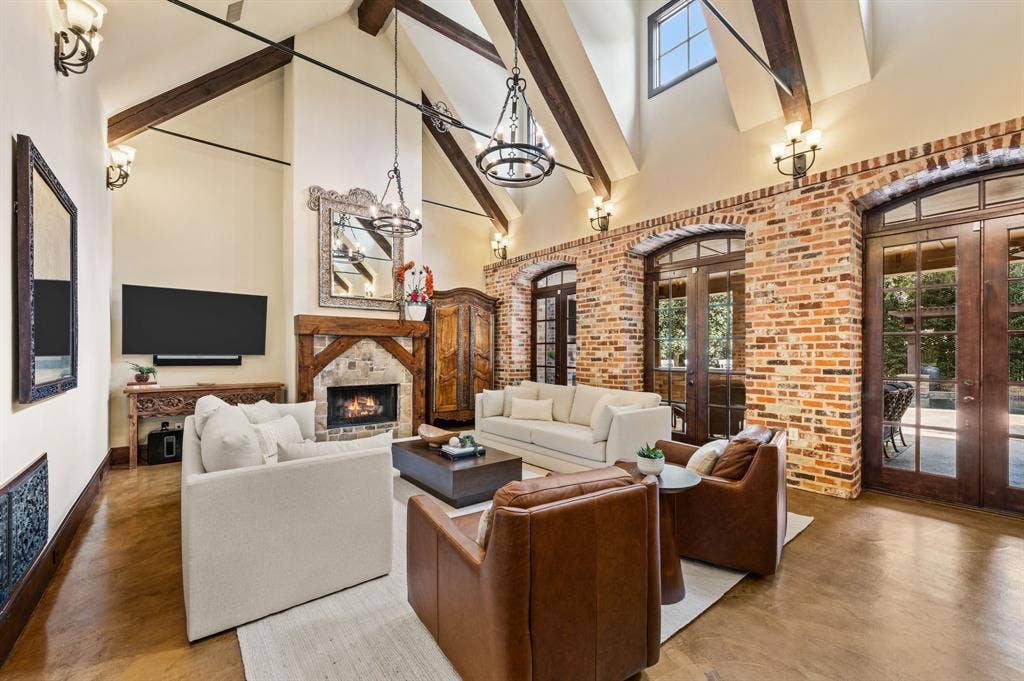 Rich in architectural character, the great room showcases striking wood beams, distinctive metal accents, and authentic antique Chicago brick walls, creating a warm and inviting atmosphere with timeless appeal.