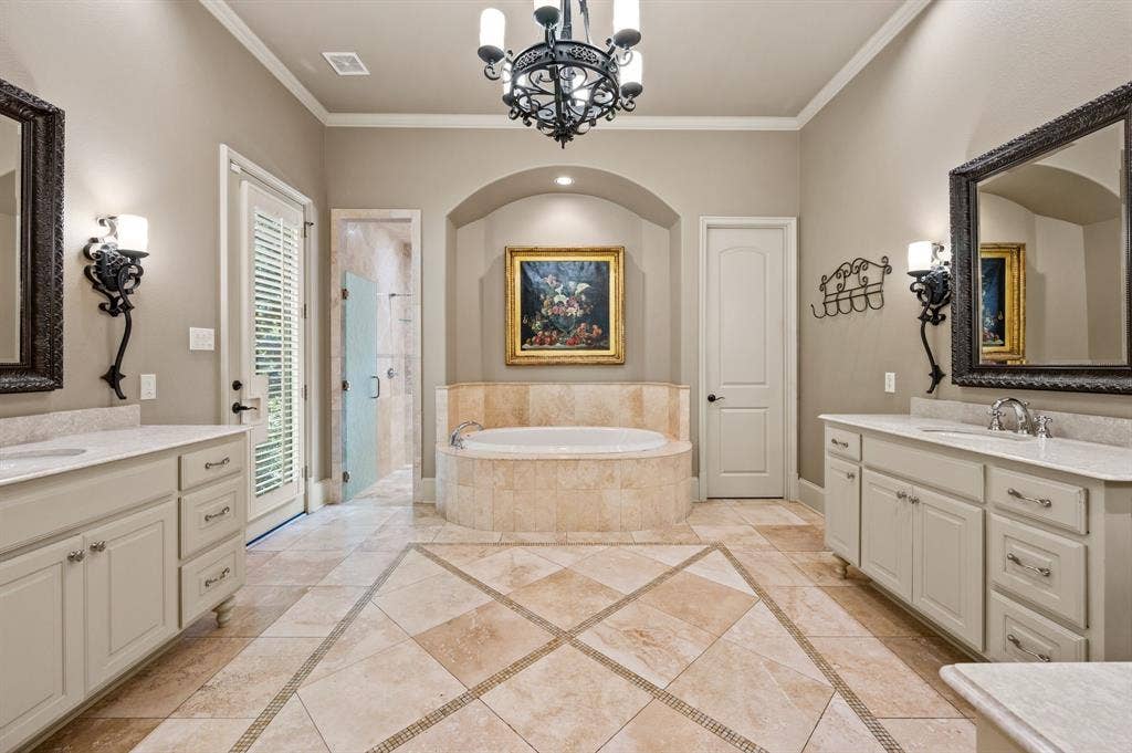 The spacious primary bath offers a luxurious retreat, featuring separate his-and-hers vanities, a dedicated makeup vanity, and a relaxing jetted soaking tub.