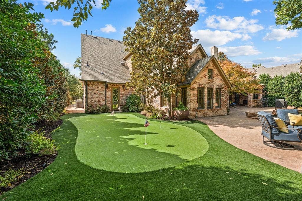 Perfect your short game in the privacy of your own backyard with a personal putting green, offering a fun and relaxing retreat for golf enthusiasts of all skill levels.