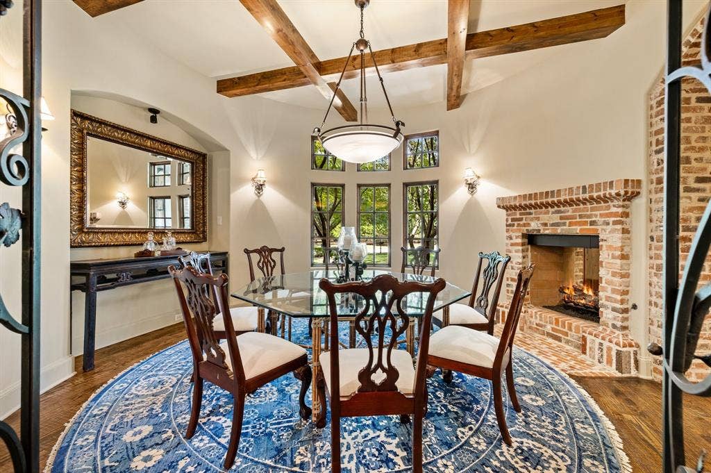 This charming circular dining area, complemented by a beautiful see-through fireplace, creates a warm and inviting setting for intimate family gatherings and memorable meals.