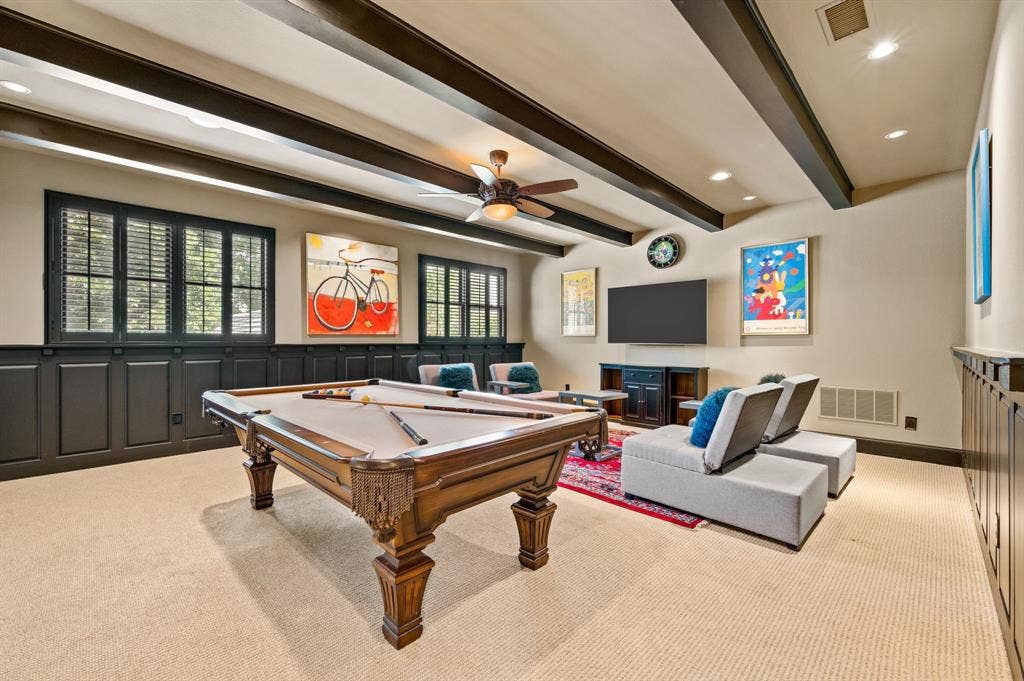The spacious upstairs game room offers ample room for a pool table and dedicated gaming area, complemented by a convenient wet bar and beverage station—perfect for entertaining family and friends.