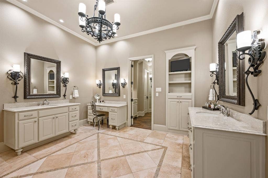 The spacious primary bath offers a luxurious retreat, featuring separate his-and-hers vanities, a dedicated makeup vanity, and a relaxing jetted soaking tub.
