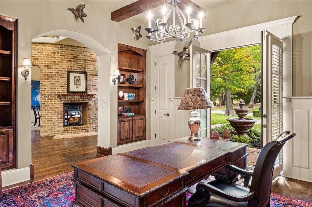 Elegant French doors from the study open to a charming private front patio, offering a peaceful outdoor retreat.