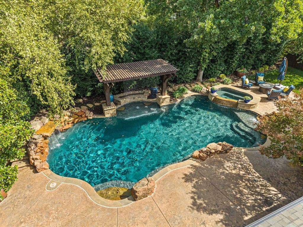 Aerial view of the pool area with mature landscaping.
