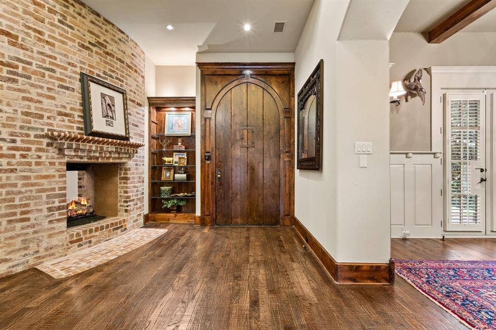 The charming antique Chicago brick fireplace creates a warm and inviting atmosphere, welcoming you into the home with timeless character and charm.