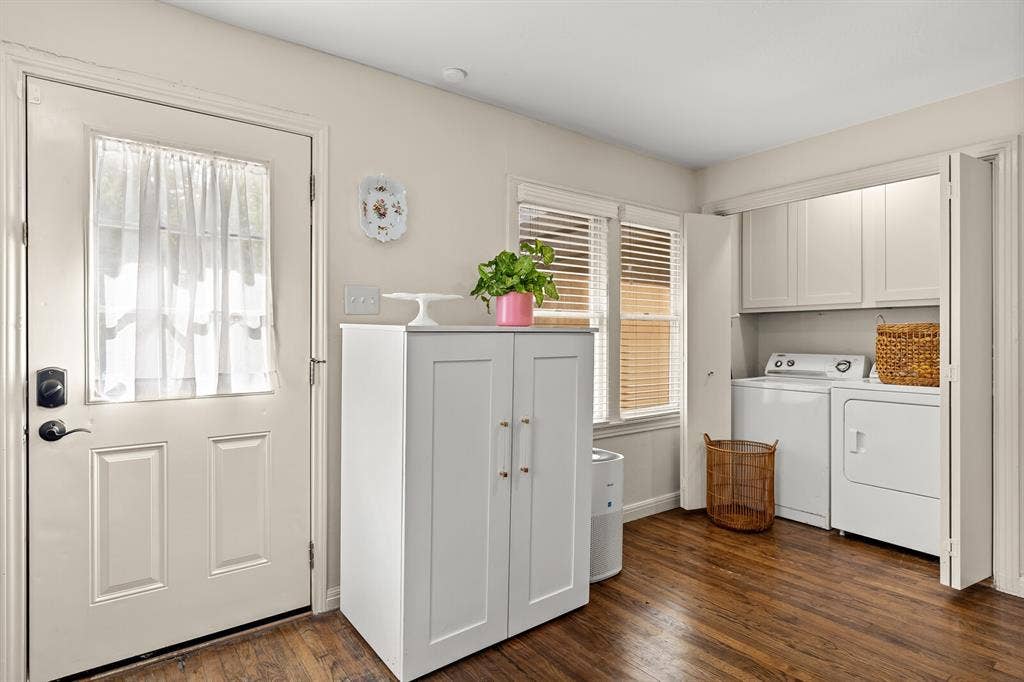 2425 S 2nd Street, Waco, TX 76706 Laundry area featuring wood-finish flooring, white upper cabinetry, and dual bifold doors