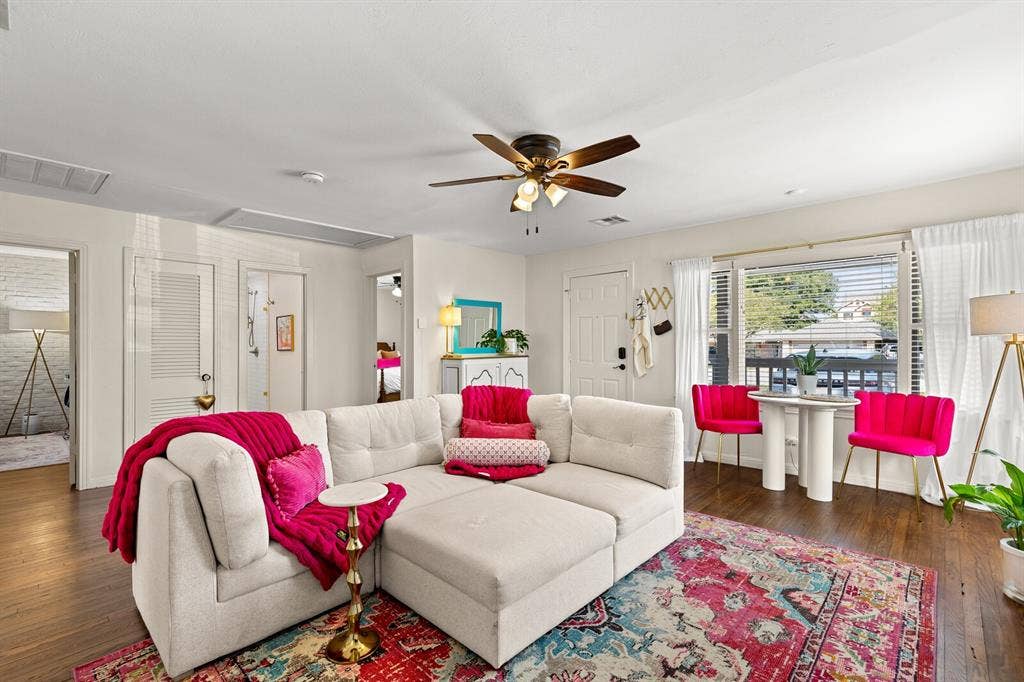 2425 S 2nd Street, Waco, TX 76706 Living space featuring wood-finish flooring, a ceiling fan with integrated lighting, and a large window with blinds