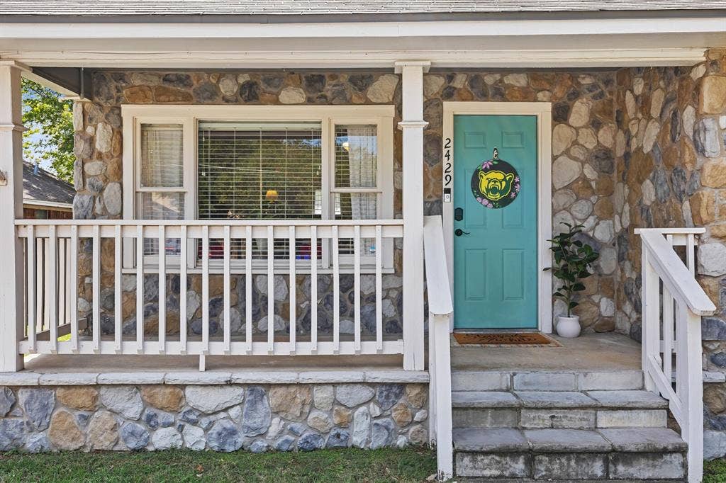 2425 S 2nd Street, Waco, TX 76706 Covered front porch with white railing, natural stone exterior siding, and concrete steps