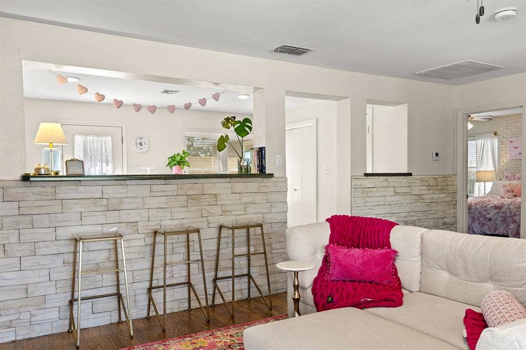 2425 S 2nd Street, Waco, TX 76706 Stacked stone partition walls with dark countertops and wood-finish flooring