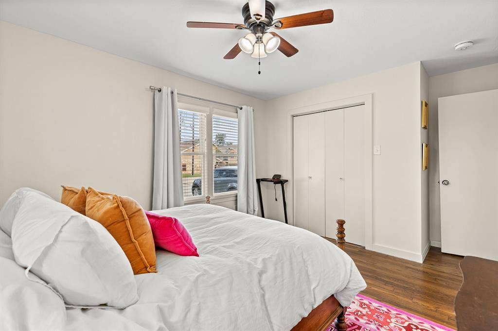 2425 S 2nd Street, Waco, TX 76706 Room featuring wood-finish flooring, a multi-blade ceiling fan with integrated lighting, and a double-door closet