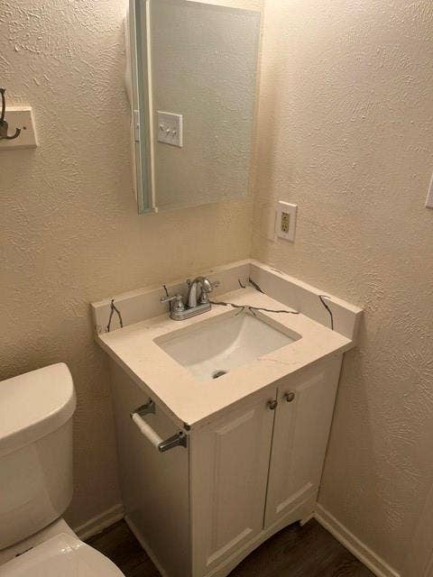 1236 Neptune Drive, Cedar Hill, TX 75104 Single-sink vanity with white cabinet storage, integrated basin, stone-composite countertop with veining, chrome faucet, and mirrored medicine cabinet