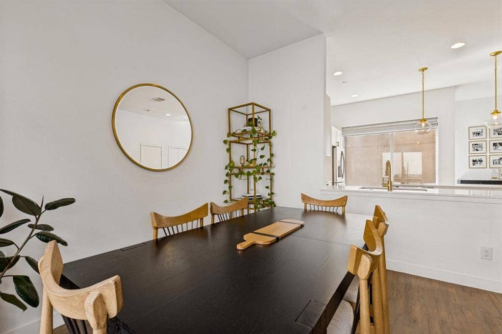 2107 Bennett Avenue, #20, Dallas, TX 75206 Wood-finish flooring, recessed lighting, and dual pendant light fixtures with metallic accents