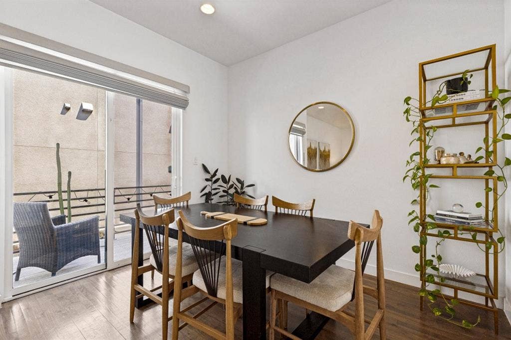 2107 Bennett Avenue, #20, Dallas, TX 75206 Wood-finish flooring, sliding glass door, recessed lighting, and wall-mounted circular mirror