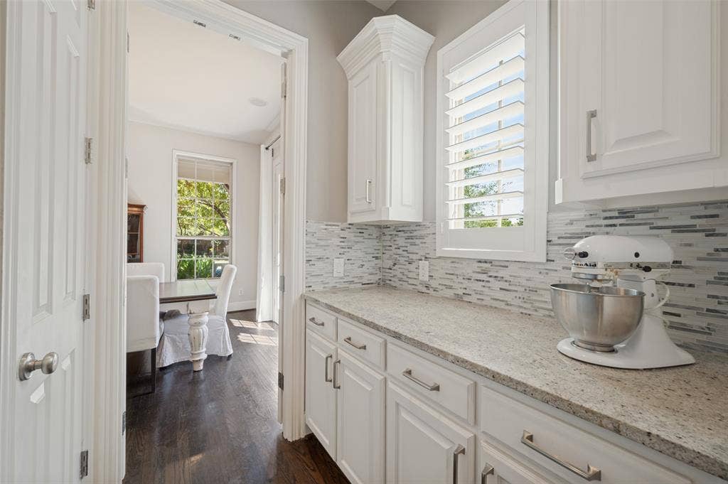 301 Longhorn Drive, McKinney, TX 75071 Chef’s kitchen with a large center island, five burner gas cooktop, double ovens, range hood and butler’s pantry.