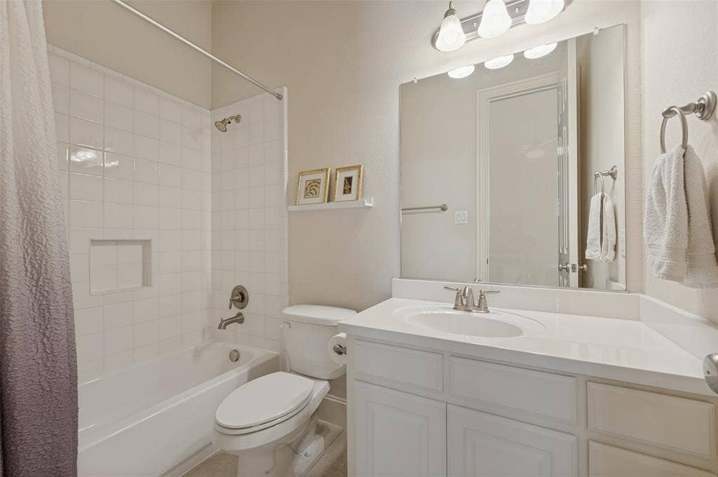 301 Longhorn Drive, McKinney, TX 75071 First floor secondary bedroom with a private ensuite bath.