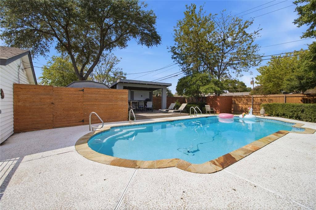 2712 Beechmont Place, Dallas, TX 75228 Your own backyard retreat! The sparkling in-ground pool takes center stage, surrounded by an expansive deck with plenty of room for lounging and entertaining. Just steps away, the covered cabana offers a shaded gathering space, while the wood privacy fencing and mature trees create an inviting outdoor setting. A dedicated fenced enclosure discreetly separates the pool equipment from the entertaining areas.
