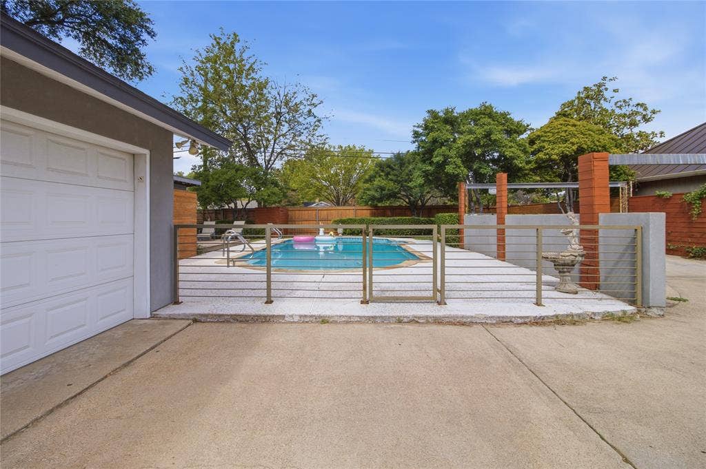 2712 Beechmont Place, Dallas, TX 75228 Step through the decorative metal gate into your own backyard retreat! The fenced pool area is thoughtfully separated from the driveway and additional parking, creating a distinct space for relaxation and entertaining. Beyond the gate, the sparkling swimming pool, expansive decking, and mature landscaping set the stage for everything from quiet afternoons in the sun to lively gatherings with friends.