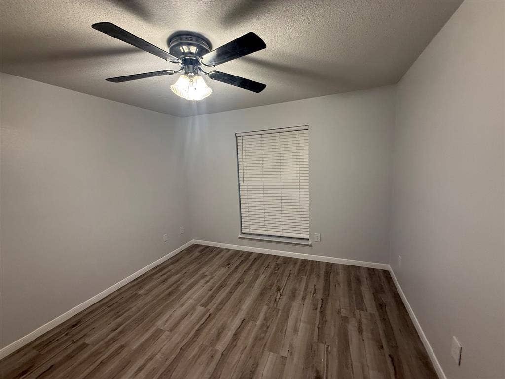 14 Heritage Way, Allen, TX 75002 Room featuring wood-finish flooring, neutral wall paint, and a ceiling fan with integrated lighting