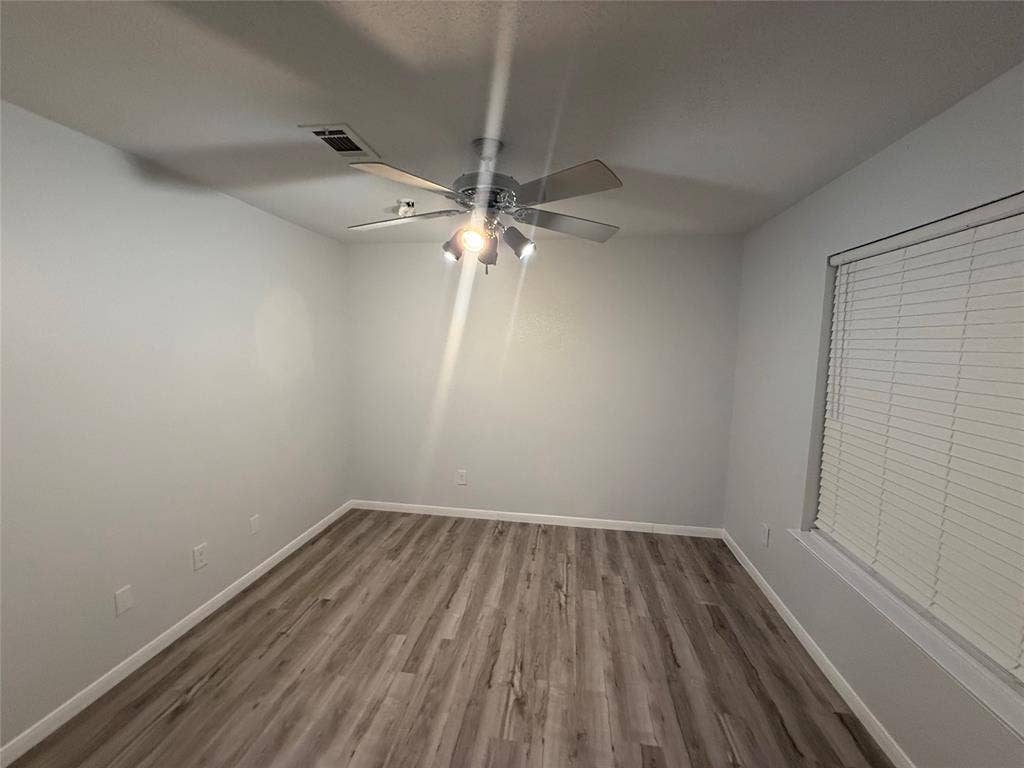14 Heritage Way, Allen, TX 75002 Room featuring wood-finish flooring, a multi-blade ceiling fan with integrated lighting, and horizontal window blinds