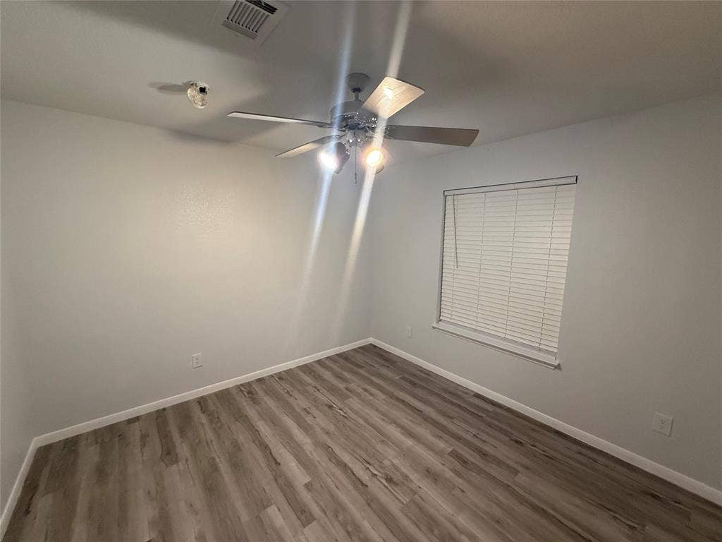 14 Heritage Way, Allen, TX 75002 Room featuring wood-finish flooring, a ceiling fan with integrated lighting, and a window with horizontal blinds