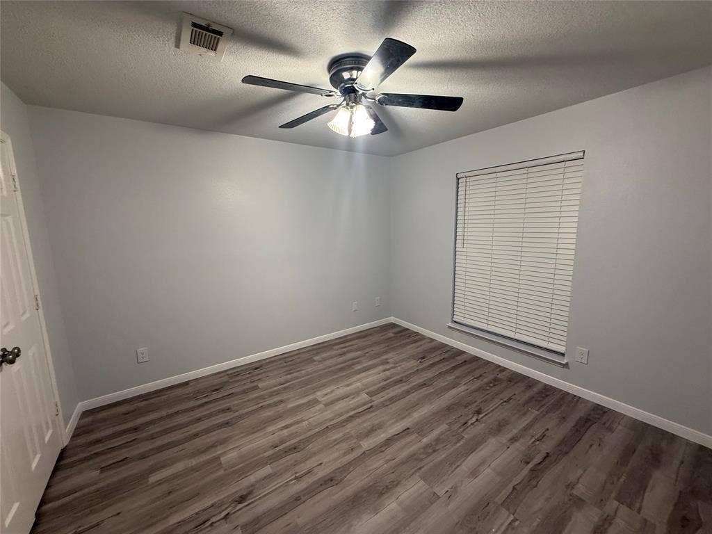 14 Heritage Way, Allen, TX 75002 Room featuring wood-finish flooring, a multi-blade ceiling fan with integrated lighting, and a single window with horizontal blinds
