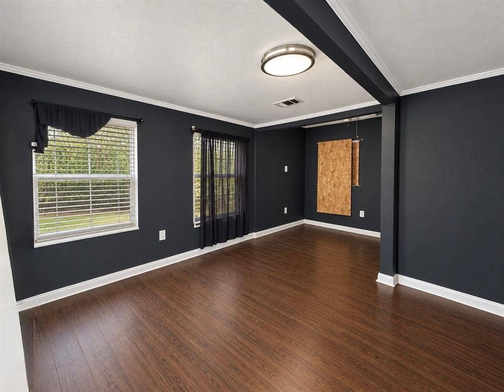 5512 Curzon Avenue, Fort Worth, TX 76107 Interior featuring dark-toned walls, wood-finish flooring, crown molding, double-pane windows, and a flush-mount ceiling light fixture