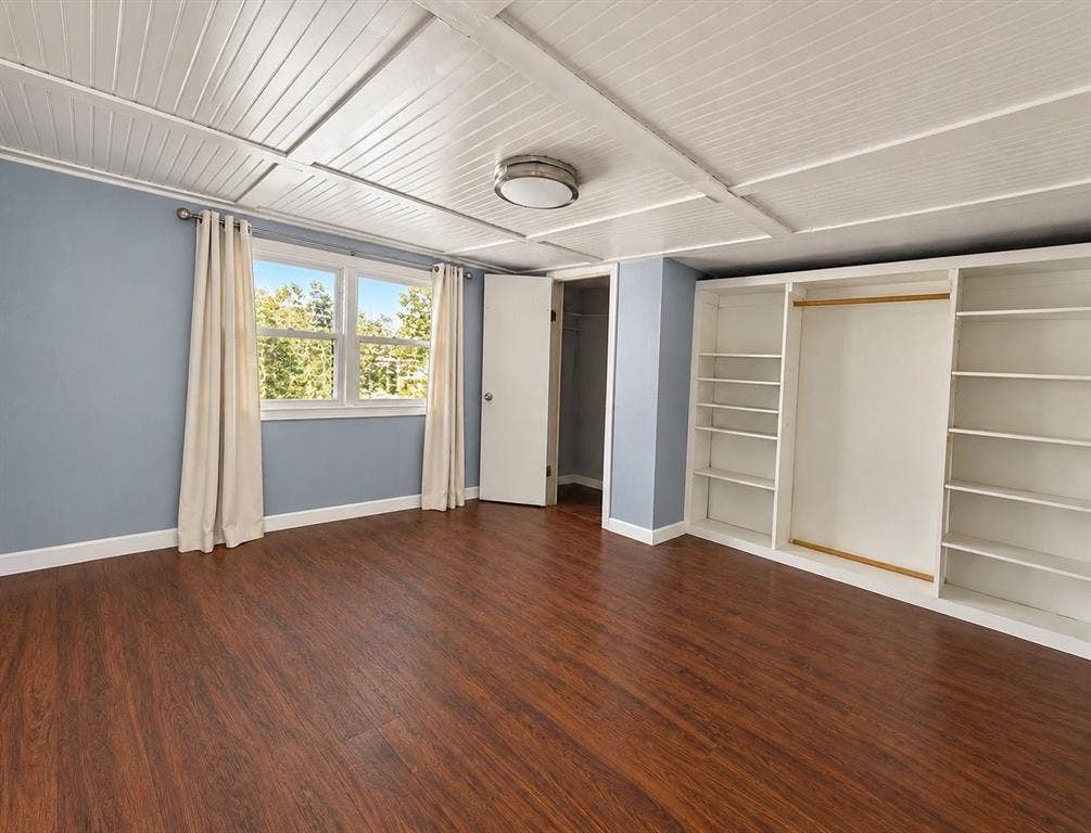 5512 Curzon Avenue, Fort Worth, TX 76107 Wood-finish flooring, white beadboard ceiling, built-in shelving unit, and central flush-mount lighting fixture