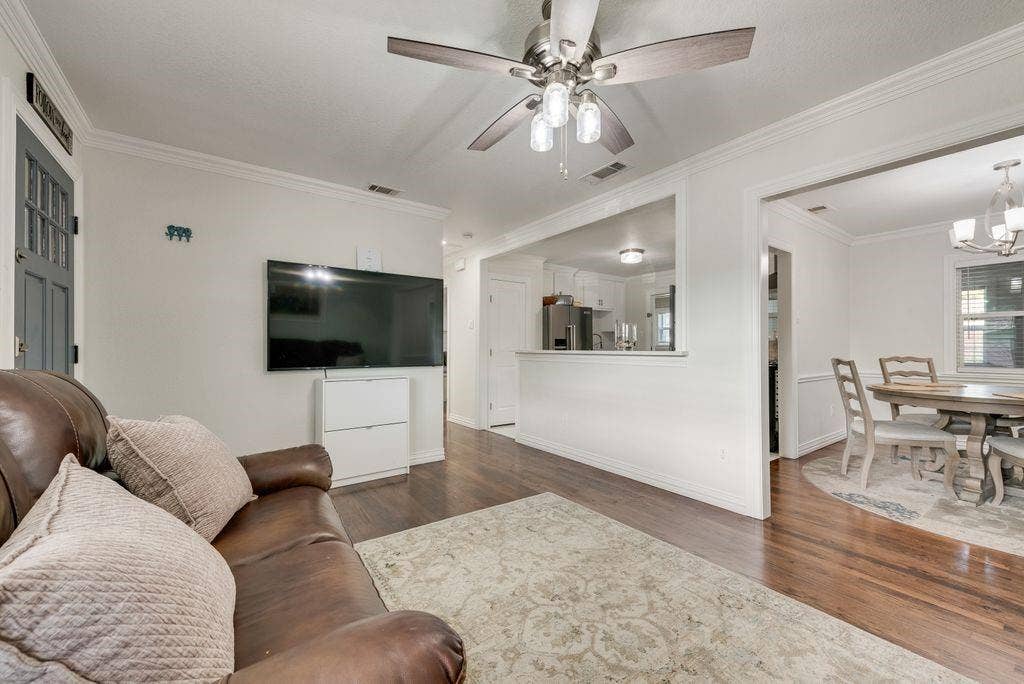 2815 Anzio Drive, Dallas, TX 75224 Wood-finish flooring, crown molding, and a multi-light ceiling fan
