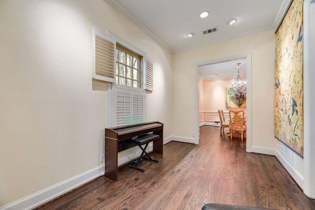 1418 Yakimo Drive, Dallas, TX 75208 Interior space featuring dark-stained wood-finish flooring, recessed lighting, and a multi-pane window with louvered shutters