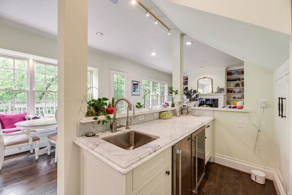 1418 Yakimo Drive, Dallas, TX 75208 Wet bar featuring stone countertops, an under-mount stainless steel sink, a professional-grade beverage refrigerator, custom cabinetry, and track lighting